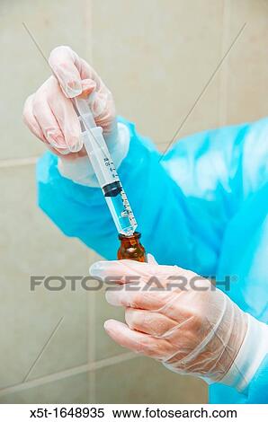 Stock Photography - Lab technician with gloves and protective clothing. Fotosearch