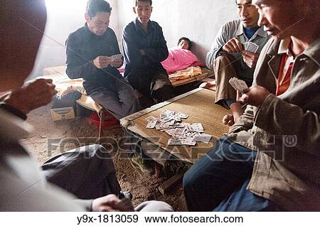 Labor workers playing a friendly game of cards at the San Huang Zhai Monastery on Song Mountain, China View Large Photo Image Stock Photo - Labor workers playing a friendly game of cards at the San Huang Zhai Monastery on Song Mountain, China. Fotosearch