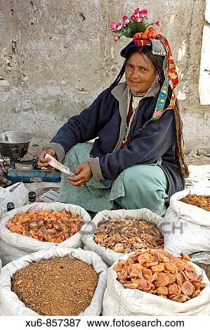 Stock Photo - Ladakhi woman selling apricots in the market Leh, Ladakh, India. Fotosearch