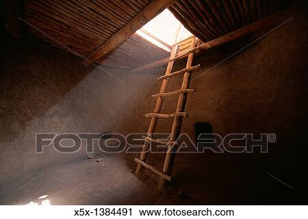 Stock Image - Ladder descends into anasazi kiva, Bandelier National Monument, New Mexico, USA. Fotosearch