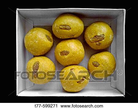 Laddu (Popularly ladu) A sweetmeat ball of numerous varieties available in India. It is made of coarsely ground gram or other pulse, or of corn_flour, mixed up with sugar and spices, and fried in ghee or oil. Pune, Maharashtra, India. View Large Photo Image Stock Image - Laddu (Popularly ladu) A sweetmeat ball of numerous varieties available in India. It is made of coarsely ground gram or other pulse, or of corn_flour, mixed up with sugar and spices, and fried in ghee or oil. Pune, Maharashtra, India.. Fotosearch