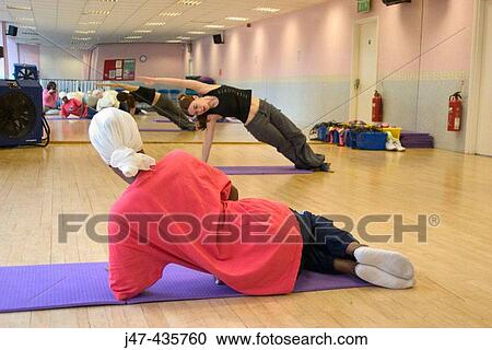 Ladies doing pilates in a gym View Large Photo Image Stock Image - Ladies doing pilates in a gym. Fotosearch