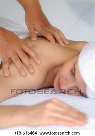 Picture - Lady enjoying therapeutic massage. Fotosearch