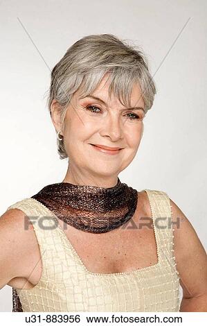 Lady in her early 60s in a studio setting View Large Photo Image Stock Photograph - Lady in her early 60s in a studio setting. Fotosearch