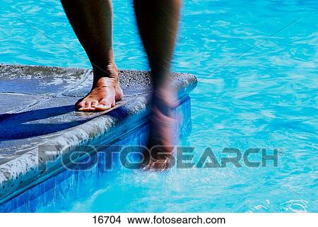 Lady testing the water View Large Photo Image Picture - Lady testing the water. Fotosearch
