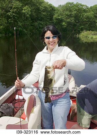 Stock Photograph - Lady who caughta bass in the Quabog River, East Brookfield. Massachusetts, USA. Fotosearch