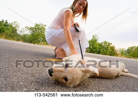 Stock Image - Lady with her pet dog. Fotosearch