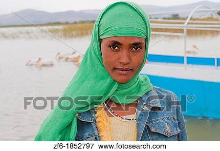 Lake Langano Ethiopia Africa Oromo Tribe young Muslim girl with scarf portrait in front of boat on lake with pelicans Lake Ziway 7 View Large Photo Image Stock Photo - Lake Langano Ethiopia Africa Oromo Tribe young Muslim girl with scarf portrait in front of boat on lake with pelicans Lake Ziway 7. Fotosearch