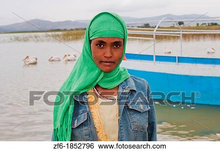 Lake Langano Ethiopia Africa Oromo Tribe young Muslim girl with scarf portrait in front of boat on lake with pelicans Lake Ziway 7 View Large Photo Image Stock Photograph - Lake Langano Ethiopia Africa Oromo Tribe young Muslim girl with scarf portrait in front of boat on lake with pelicans Lake Ziway 7. Fotosearch