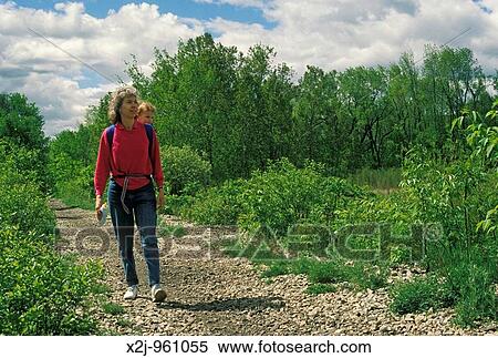 Lake Orion, Michigan - Susan Newell and her daughter, Mariel West, 18 months, walk on the Paint Creek Trail, a former railroad that has been converted to a trail for walking and bicycling and for cross country skiing in winter MR View Large Photo Image Stock Photography - Lake Orion, Michigan - Susan Newell and her daughter, Mariel West, 18 months, walk on the Paint Creek Trail, a former railroad that has been converted to a trail for walking and bicycling and for cross country skiing in winter MR. Fotosearch
