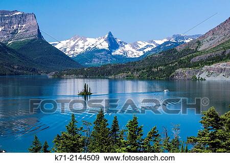 Lake St. Mary and Wild Goose Island with tour boat in Glacier National Park, Montana, USA. View Large Photo Image Stock Photo - Lake St. Mary and Wild Goose Island with tour boat in Glacier National Park, Montana, USA.. Fotosearch