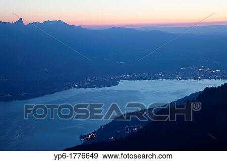Stock Photo - Lake Thun and mountains at dusk, Niederhorn, Switzerland. Fotosearch