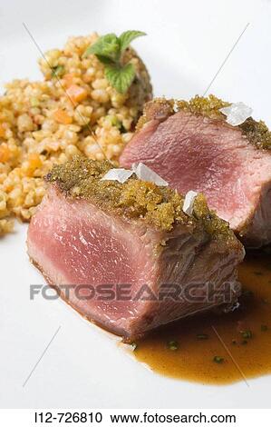 Lamb loin with aromatic herbs and grain couscous at restaurant A Estacion by chefs Xoan Crujeiras and Beatriz Sotelo, Cambre. La Corua province, Galicia, Spain View Large Photo Image Stock Image - Lamb loin with aromatic herbs and grain couscous at restaurant A Estacion by chefs Xoan Crujeiras and Beatriz Sotelo, Cambre. La Corua province, Galicia, Spain. Fotosearch