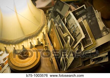 Stock Photograph - Lamp and old photos. Fotosearch