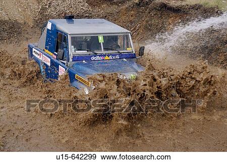 Stock Photo - Land Rover Defender 90, racing at the Rallye Dresden Breslau 2007, crossing a ford.. Fotosearch
