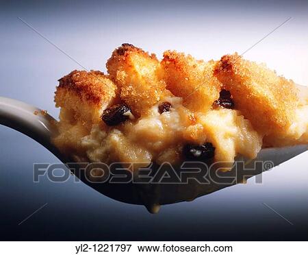 Stock Photo - Landscape of Bread & Butter Pudding on a white spoon. Fotosearch