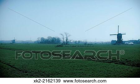 Landscape of traditional windmills in Kinderdijk, Rotterdam, Nederland View Large Photo Image Stock Photo - Landscape of traditional windmills in Kinderdijk, Rotterdam, Nederland. Fotosearch