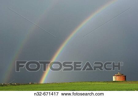 Stock Photo - Landscape with raimbow and old dovecote in Villafafila Lagoon. Zamora province, Castilla-Le? n, Spain.. Fotosearch