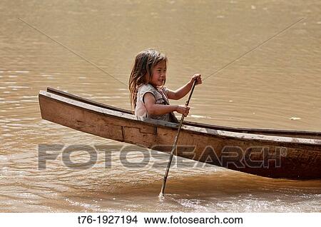 Lanten girl in her dugout canoe on the Nam Ha River, Luang Nam Tha, Laos View Large Photo Image Picture - Lanten girl in her dugout canoe on the Nam Ha River, Luang Nam Tha, Laos. Fotosearch