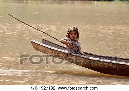 Lanten girl in her dugout canoe on the Nam Ha River, Luang Nam Tha, Laos View Large Photo Image Stock Image - Lanten girl in her dugout canoe on the Nam Ha River, Luang Nam Tha, Laos. Fotosearch