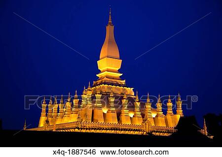 Stock Photograph - Laos Vientiane Nighttime photo of the pagoda lit. Fotosearch