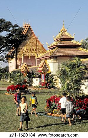 Laos, Vientiane, Wat That Luang Neua buddhist temple, children. View Large Photo Image Picture - Laos, Vientiane, Wat That Luang Neua buddhist temple, children.. Fotosearch