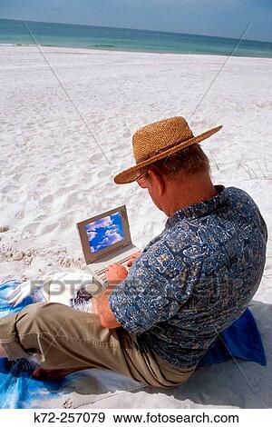 Stock Photo - laptop used at beach. Fotosearch