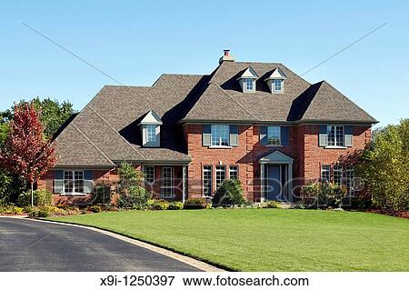 Large brick home with arched entry and blue door View Large Photo Image Stock Photo - Large brick home with arched entry and blue door. Fotosearch