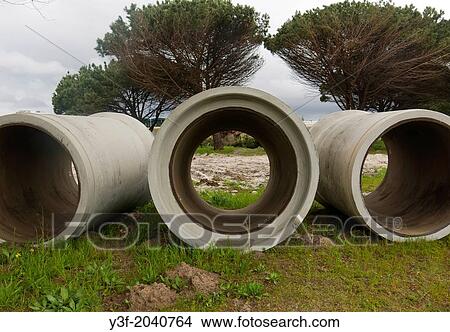 Large diameter concrete pipes ready to be laid as a storm water drainage pipeline. Cape Town, South Africa. View Large Photo Image Picture - Large diameter concrete pipes ready to be laid as a storm water drainage pipeline. Cape Town, South Africa.. Fotosearch