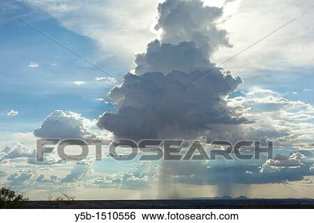 Large storm cloud dropping rain in a column with surrounding blue skies View Large Photo Image Stock Photograph - Large storm cloud dropping rain in a column with surrounding blue skies. Fotosearch