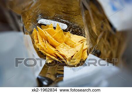 Picture - Last Doritos chips inside the plastic bag. Fotosearch