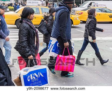Last minute Christmas shoppers in Herald Square in New York View Large Photo Image Stock Photo - Last minute Christmas shoppers in Herald Square in New York. Fotosearch