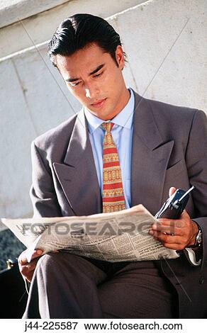 Latin businessman reading the paper View Large Photo Image Stock Photo - Latin businessman reading the paper. Fotosearch