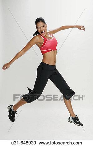 Latin girl jumping and smiling View Large Photo Image Stock Photo - Latin girl jumping and smiling. Fotosearch