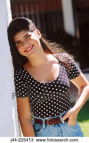 Latin girl leaning on column and smiling View Large Photo Image Stock Image - Latin girl leaning on column and smiling. Fotosearch