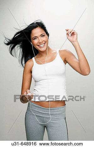 Latin girl listening and enjoying music View Large Photo Image Stock Photograph - Latin girl listening and enjoying music. Fotosearch