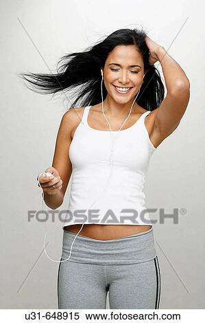 Latin girl listening and enjoying music View Large Photo Image Stock Photography - Latin girl listening and enjoying music. Fotosearch