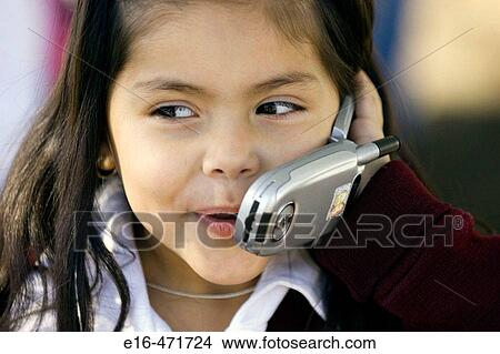 Latin girl on phone View Large Photo Image Picture - Latin girl on phone. Fotosearch
