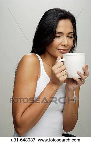 Stock Photo - latin girl smelling coffee. Fotosearch