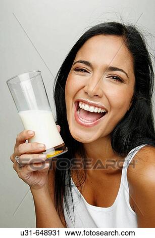 Latin girl with a glass of milk showing milk moustache smiling View Large Photo Image Stock Image - Latin girl with a glass of milk showing milk moustache smiling. Fotosearch