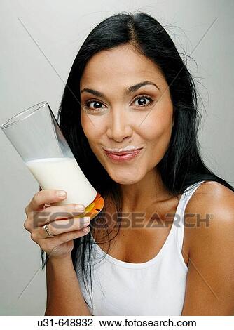 Latin girl with a glass of milk showing milk moustache View Large Photo Image Stock Image - Latin girl with a glass of milk showing milk moustache. Fotosearch