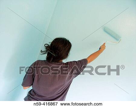Latin-Italian woman painting wall with roller View Large Photo Image Stock Photo - Latin-Italian woman painting wall with roller. Fotosearch