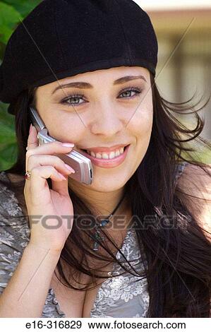 Latin lady on cell phone View Large Photo Image Stock Photo - Latin lady on cell phone. Fotosearch