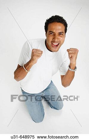 Stock Photography - Latin Man celebrates victory. Fotosearch