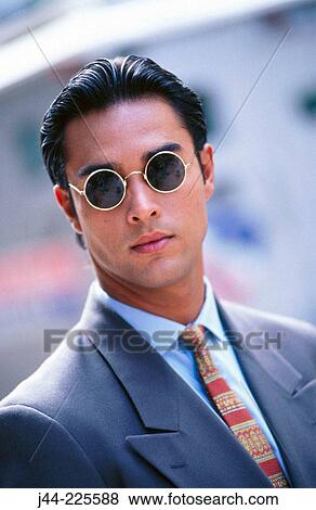 Latin man with sunglasses in the street View Large Photo Image Stock Photo - Latin man with sunglasses in the street. Fotosearch