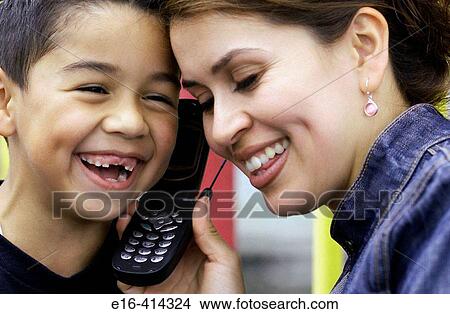 Latin mother and son on cell phone View Large Photo Image Picture - Latin mother and son on cell phone. Fotosearch