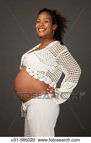 Stock Image - Latin pregnant woman smiling.. Fotosearch