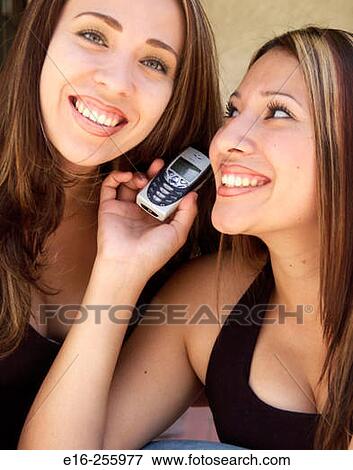 Latin sisters on phone View Large Photo Image Stock Photo - Latin sisters on phone. Fotosearch