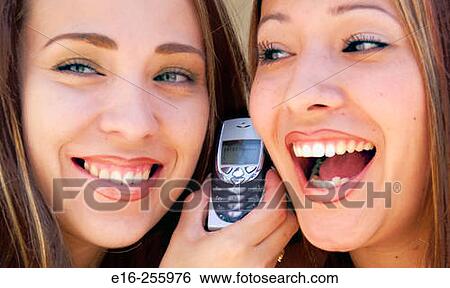 Latin sisters on phone View Large Photo Image Stock Photograph - Latin sisters on phone. Fotosearch