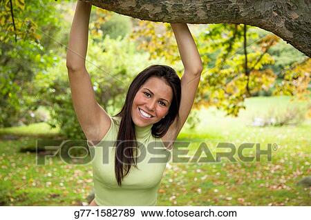 Latin woman in a park. View Large Photo Image Stock Photo - Latin woman in a park.. Fotosearch